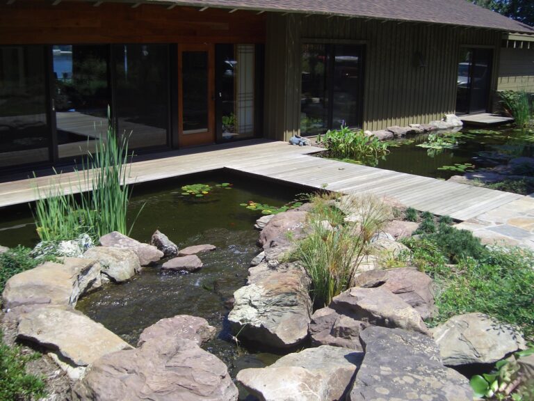 bridge crossing pond home entrance