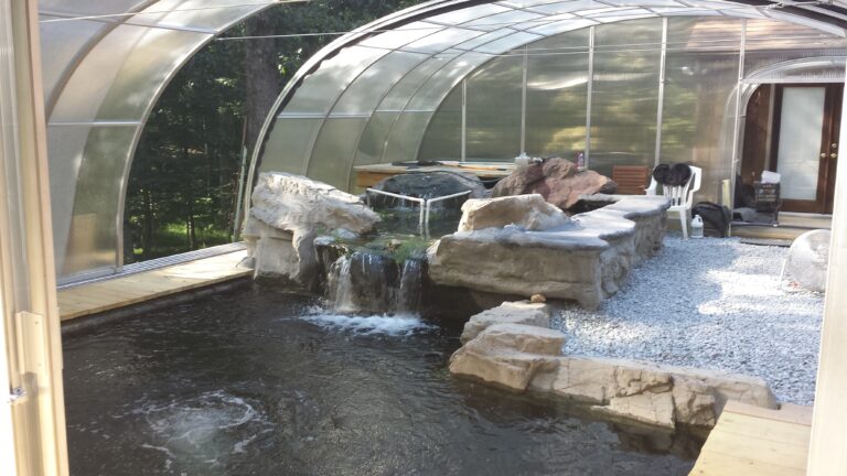 Koi pond in a greenhousewith retractable roof sections