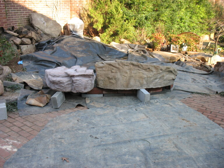 WF foundation rebuild cast boulder placement on the patio