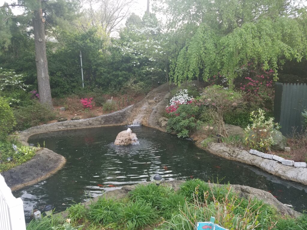 Boulder fountain in large pond